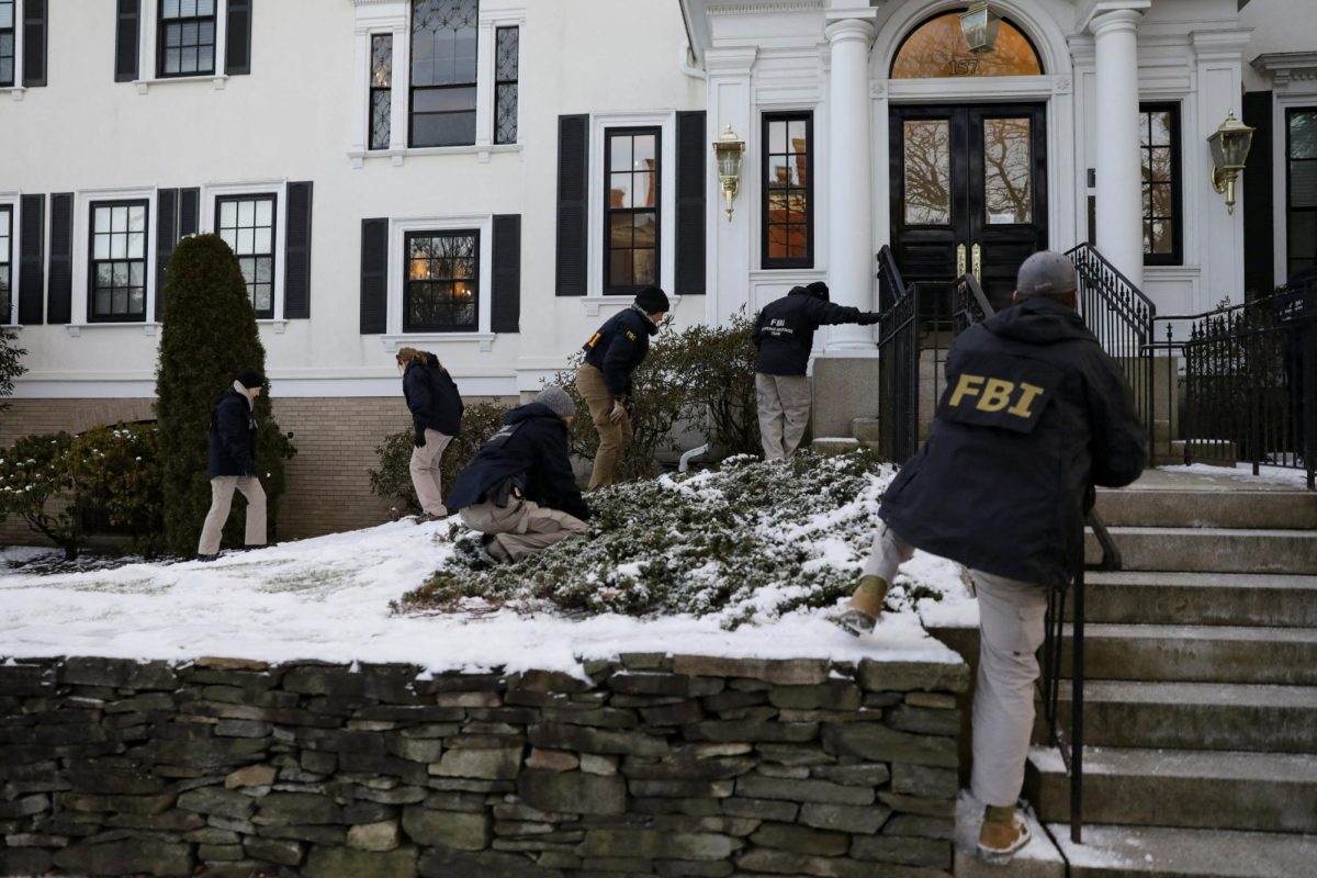 Law enforcement officers canvass Waterman Street as the manhunt continues for the gunman, following a shooting at Brown University in Providence, Rhode Island, U.S. December 15, 2025.  REUTERS/Taylor Coester