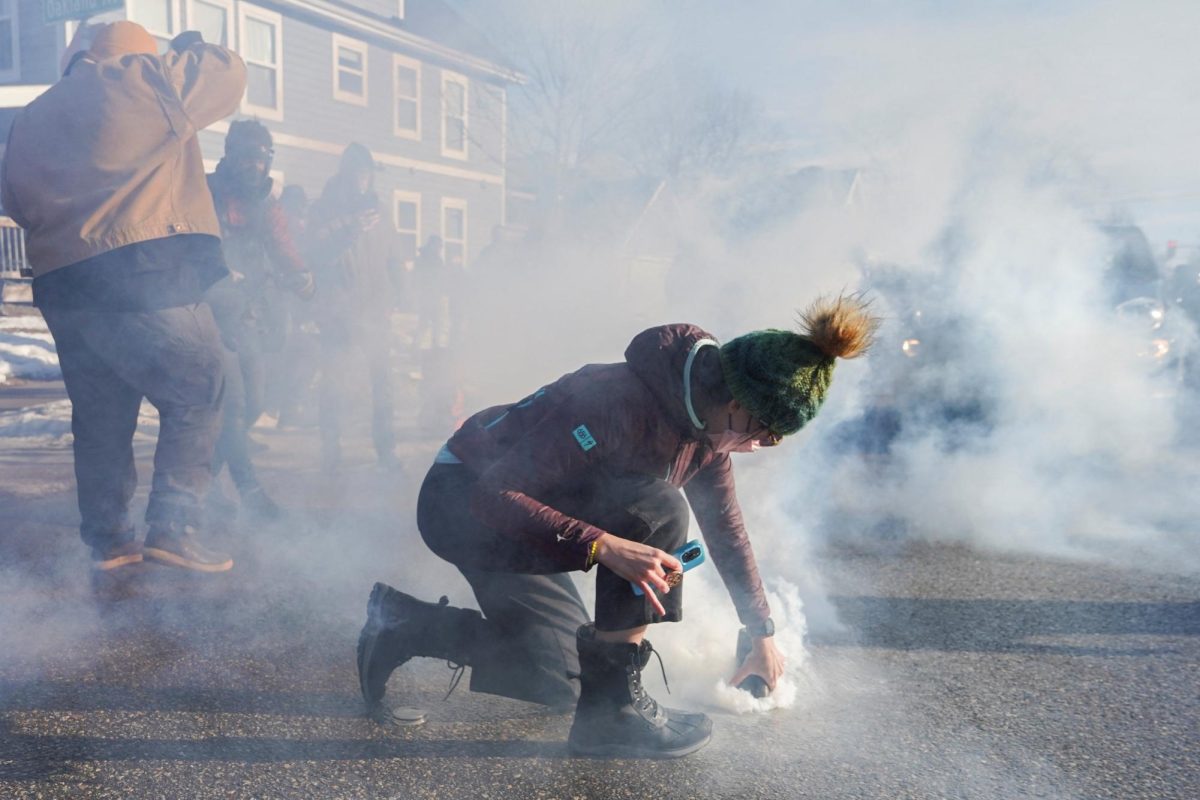 A person covers a tear gas canister used by federal agents during an immigration raid days after an ICE agent fatally shot Renee Nicole Good, in Minneapolis, Minnesota, U.S., January 13, 2026. REUTERS/Ryan Murphy