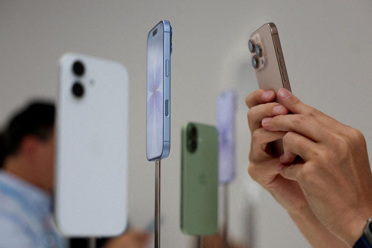 A person uses a phone to capture iPhones on display during Apple's event at the Steve Jobs Theater in Cupertino, California, U.S. September 9, 2025. REUTERS/Manuel Orbegozo