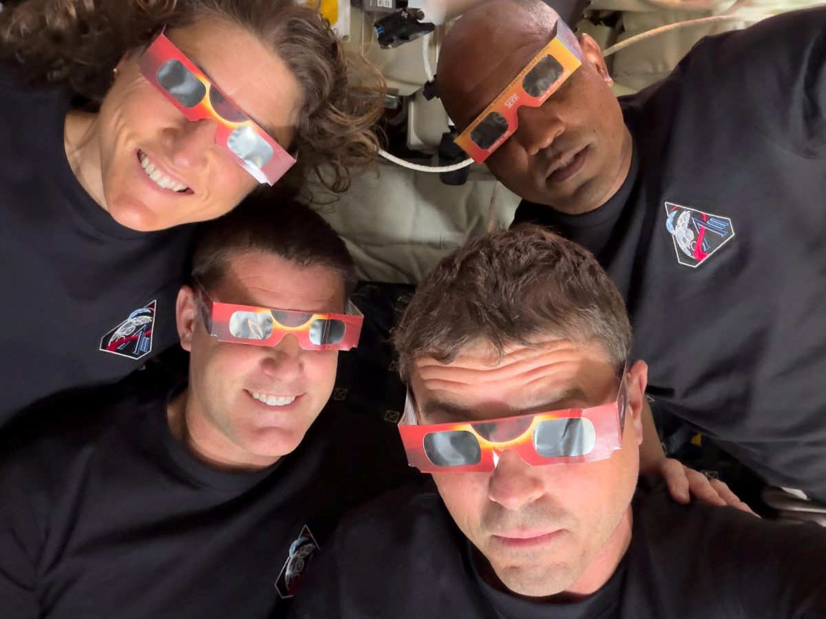 The Artemis II crew of NASA astronauts Christina Koch, Reid Wiseman, Victor Glover and Canadian Space Agency (CSA) astronaut Jeremy Hansen pose with their eclipse glasses used to protect their eyes for the Orion spacecraft's flyby of the Moon April 6, 2026.   Picture taken with a mobile phone.   NASA/Handout via REUTERS