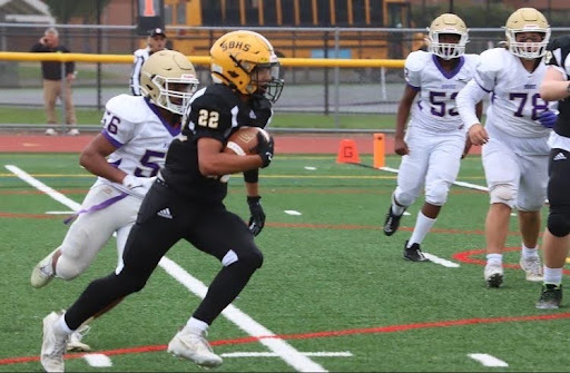 Oscar (#22) running the ball in a game against Monroe his freshman year.
